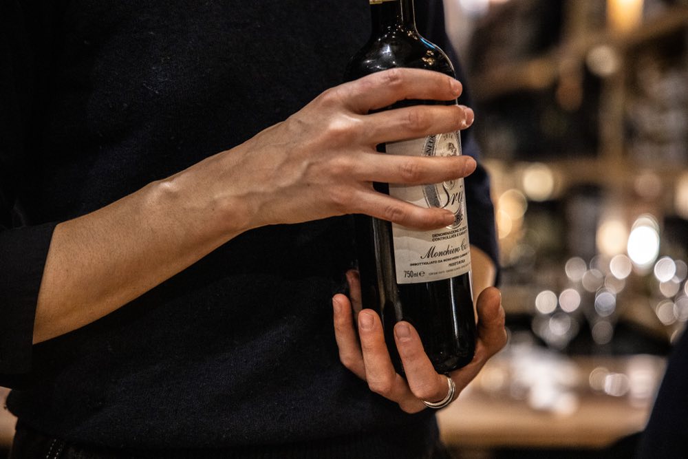 A sommelier presenting a bottle of Italian wine